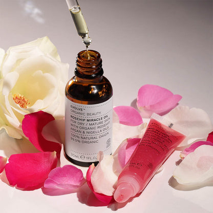 Rosehip Miracle Oil and Bio-retinol Glossy Lip oil with rose petals background