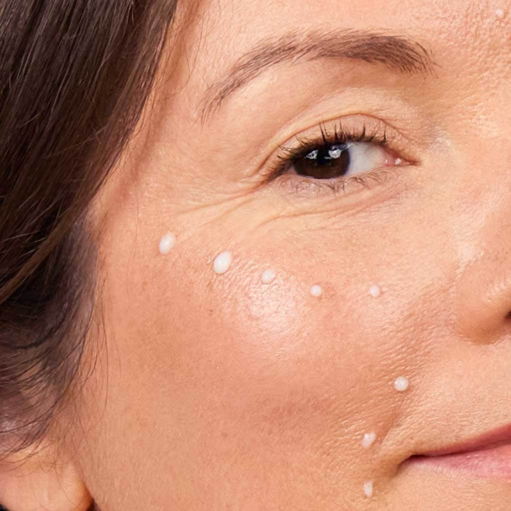 skincare model wearing lifting serum dots on cheek