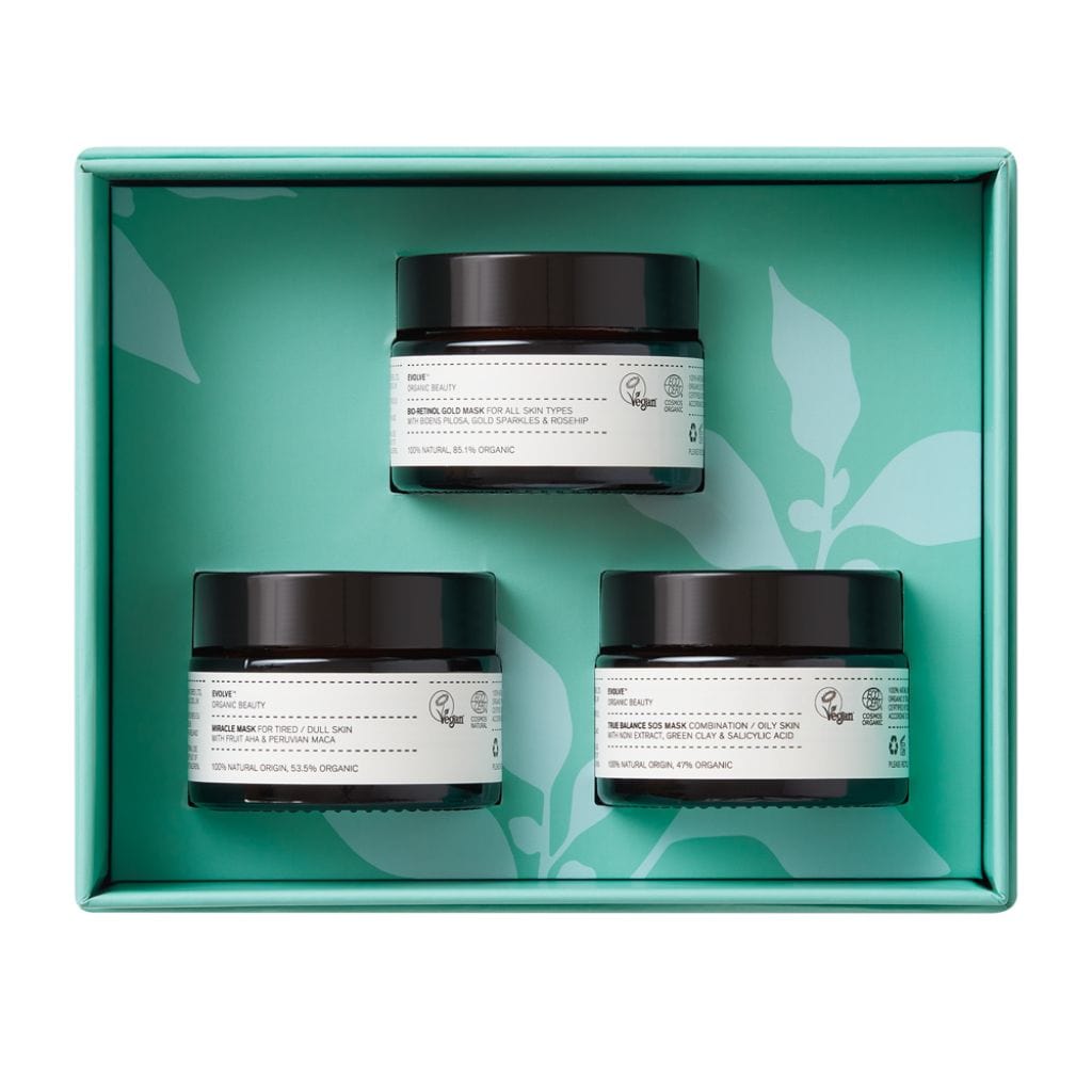 True Balance SOS mask clarifying clay mask in an amber glass jar, Miracle AHA 3 minute mask in an amber glass jar and bio-retinol gold face mask in amber glass jar packaged in turquoise Evolve Organic Beauty gift box 